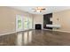 Bright and airy living room with fireplace, backyard access, and sleek wood-style flooring at 717 Samuel Cary Dr, Cary, NC 27511