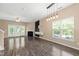 Inviting living room featuring fireplace, modern lighting, and bright windows with backyard views at 717 Samuel Cary Dr, Cary, NC 27511