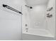 Modern shower and bathtub with matte fixtures, shower caddy, and light bright interior at 717 Samuel Cary Dr, Cary, NC 27511
