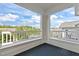 Balcony view of the surrounding buildings and leafy trees against a bright cloudy sky at 735 Portstewart Dr, Cary, NC 27519