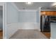 An empty dining space featuring neutral carpet and wainscoting detail on the blue walls at 735 Portstewart Dr, Cary, NC 27519