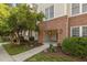 A ground-level entrance to a condo building with unit number above doorway, brick accents and landscaping at 735 Portstewart Dr, Cary, NC 27519