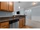 Kitchen area with stainless steel dishwasher and double sink, granite countertops, and wooden cabinets at 735 Portstewart Dr, Cary, NC 27519
