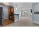 An open-concept space featuring light blue walls, wood-style floors and light carpet, with kitchen bar at 735 Portstewart Dr, Cary, NC 27519