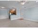 Open living space with neutral carpet, blue walls, and a view of the kitchen and entrance at 735 Portstewart Dr, Cary, NC 27519