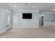 A bright living area features neutral carpet, blue walls, and a door leading to the exterior at 735 Portstewart Dr, Cary, NC 27519