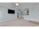 A bright and airy living room with blue walls, neutral carpet, and adjacent kitchen area at 735 Portstewart Dr, Cary, NC 27519
