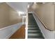 Carpeted staircase with white handrail with contrasting colored walls and floors at 735 Portstewart Dr, Cary, NC 27519
