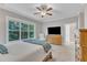 Spacious bedroom with a ceiling fan, comfortable chair, and a large window with wooded view at 736 Varina Ln, Fuquay Varina, NC 27526