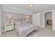 Neutral bedroom featuring plush carpeting, bedside tables with lamps, and a decorative bed at 736 Varina Ln, Fuquay Varina, NC 27526