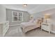 Cozy bedroom with plush carpet, natural light from the window, and coordinated bedside tables and lamps at 736 Varina Ln, Fuquay Varina, NC 27526