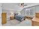 Bedroom with carpet flooring, fan, large window and neutral walls allowing for customization at 736 Varina Ln, Fuquay Varina, NC 27526