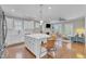Open-concept kitchen with white cabinets, a large island, and views into the living room at 736 Varina Ln, Fuquay Varina, NC 27526