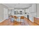 Spacious kitchen with white cabinetry, island seating, and modern appliances for cooking and entertaining at 736 Varina Ln, Fuquay Varina, NC 27526