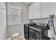 Well-equipped laundry area with washer, dryer, window and plenty of storage space at 736 Varina Ln, Fuquay Varina, NC 27526