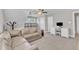 Living room featuring a comfortable sectional couch, carpet, and a ceiling fan at 736 Varina Ln, Fuquay Varina, NC 27526