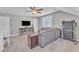 Living room featuring a comfortable sectional, carpet flooring, and a ceiling fan at 736 Varina Ln, Fuquay Varina, NC 27526