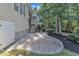 Backyard patio featuring brick pavers, landscaped yard and stair access to the home's screened porch at 736 Varina Ln, Fuquay Varina, NC 27526
