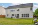 The backyard has ample space and features a stone patio with outdoor seating and a grill at 7612 Vista Del Rey Ln, Raleigh, NC 27613