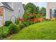 Lush green backyard featuring a well-maintained lawn, a wooden fence, and mature trees for added privacy at 7612 Vista Del Rey Ln, Raleigh, NC 27613