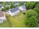 Aerial view of a fenced backyard with patio, fire pit, and lush green lawn at 7612 Vista Del Rey Ln, Raleigh, NC 27613