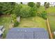 Aerial view of a spacious backyard with a shed, lawn, and privacy fence at 7612 Vista Del Rey Ln, Raleigh, NC 27613