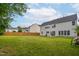 Expansive backyard featuring a well-maintained lawn and a wooden fence for privacy at 7612 Vista Del Rey Ln, Raleigh, NC 27613