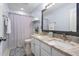 Stylish bathroom features double sinks, granite countertops, a large mirror, and decorative shower curtain at 7612 Vista Del Rey Ln, Raleigh, NC 27613