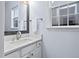 Clean bathroom with a white vanity, granite countertop, modern fixtures, and natural light at 7612 Vista Del Rey Ln, Raleigh, NC 27613