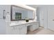 Bathroom boasting a double vanity with granite countertops, decorative mirror, and ample cabinet space at 7612 Vista Del Rey Ln, Raleigh, NC 27613