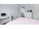 Comfortable bedroom with hardwood floors, white trim, desk, and doorway to hallway at 7612 Vista Del Rey Ln, Raleigh, NC 27613