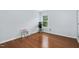 Bright bedroom features hardwood floors, a large window and simple décor at 7612 Vista Del Rey Ln, Raleigh, NC 27613