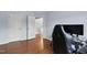 Bedroom features hardwood floors, a doorway to the hallway, and a gaming setup with a black chair at 7612 Vista Del Rey Ln, Raleigh, NC 27613