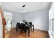 Dining room with hardwood floors, stylish light fixture, and seating for four at 7612 Vista Del Rey Ln, Raleigh, NC 27613