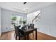Dining room with a view of the foyer, modern lighting, seating for four and wainscoting at 7612 Vista Del Rey Ln, Raleigh, NC 27613