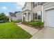 Close up of charming two-story home with lush landscaping and a well-maintained walkway leading to the entrance at 7612 Vista Del Rey Ln, Raleigh, NC 27613