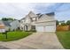 Beautiful two-story home with a manicured lawn, featuring a two-car garage and charming architectural details at 7612 Vista Del Rey Ln, Raleigh, NC 27613