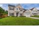 Inviting two-story home with a lush green lawn, showcasing a two-car garage and classic architectural design at 7612 Vista Del Rey Ln, Raleigh, NC 27613
