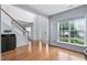 Inviting foyer featuring a staircase, hardwood floors, and a large window for natural light at 7612 Vista Del Rey Ln, Raleigh, NC 27613