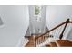 Bright foyer featuring wood stairs, modern chandelier, and natural light through a large window at 7612 Vista Del Rey Ln, Raleigh, NC 27613