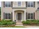 Welcoming front entrance with a dark brown door, surrounded by meticulously arranged landscaping and stone borders at 7612 Vista Del Rey Ln, Raleigh, NC 27613