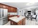 Open kitchen with granite countertops, stainless steel appliances, and view to dining and living rooms at 7612 Vista Del Rey Ln, Raleigh, NC 27613