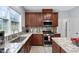 Updated kitchen with granite countertops, stainless steel appliances, and wood cabinets at 7612 Vista Del Rey Ln, Raleigh, NC 27613