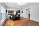 Open-concept living room with hardwood floors flowing into a view of the kitchen with cherry cabinets at 7612 Vista Del Rey Ln, Raleigh, NC 27613