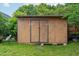 A shed with double doors sits on a concrete foundation at 7612 Vista Del Rey Ln, Raleigh, NC 27613