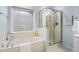 Close up on the bathroom featuring a bathtub and glass enclosed shower at 7612 Vista Del Rey Ln, Raleigh, NC 27613