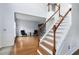 Elegant staircase with white risers, wood treads, and a continuous handrail leads to the upper level at 7612 Vista Del Rey Ln, Raleigh, NC 27613