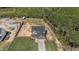 Aerial view of a traditional two-story home with attached garage, fenced backyard, and green lawn at 784 Cypress Rd, Cameron, NC 28326