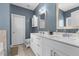 Bathroom featuring a double sink vanity, stylish mirrors, and a neutral color scheme at 784 Cypress Rd, Cameron, NC 28326