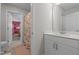 This bathroom features a white vanity, floral shower curtain, and access to an adjacent bedroom at 784 Cypress Rd, Cameron, NC 28326